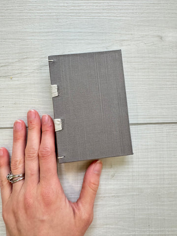 Hand-Bound Book: Dark silver fabric, tape binding, 3.25 x 4.75 inches